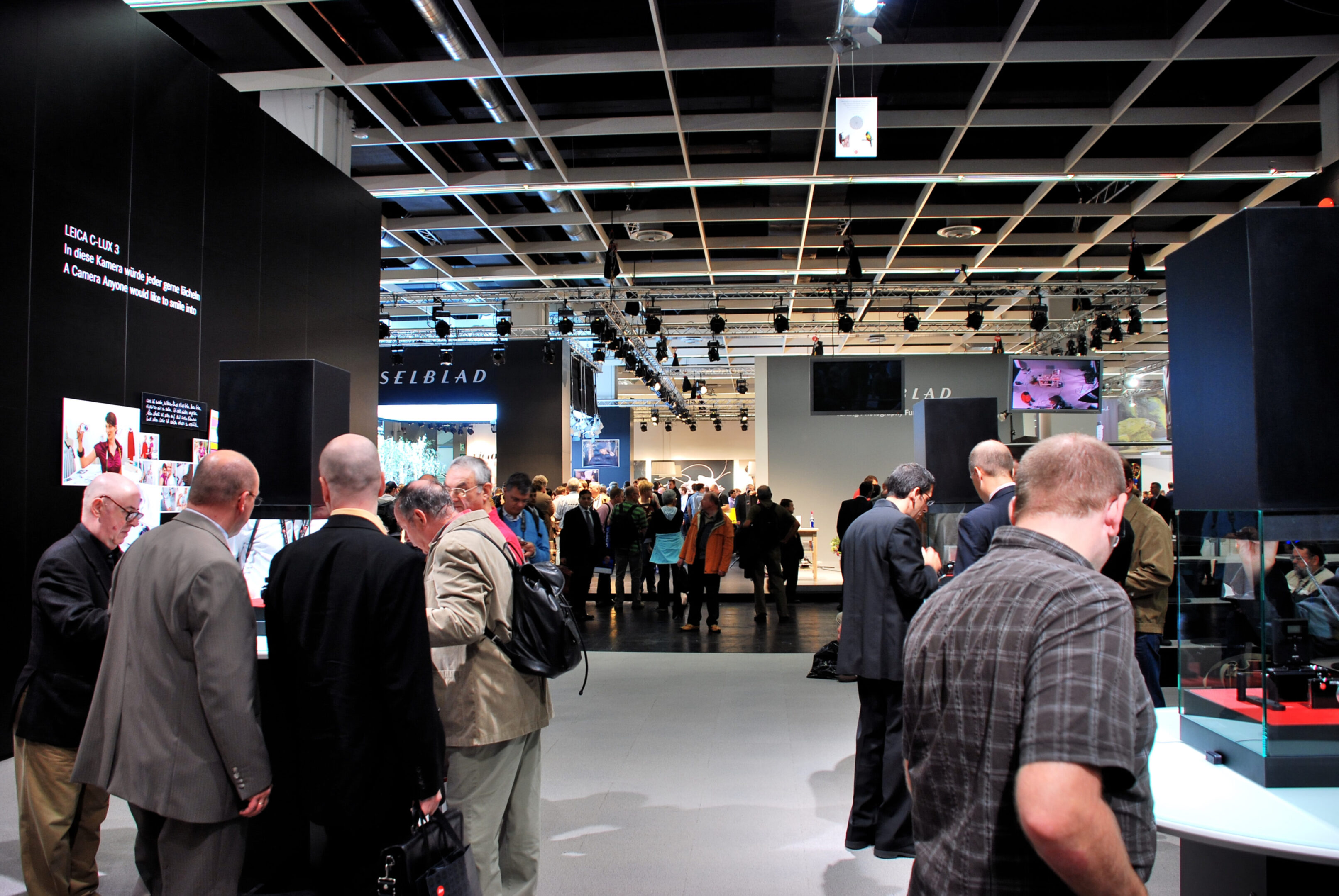 A group of people standing around in an event.