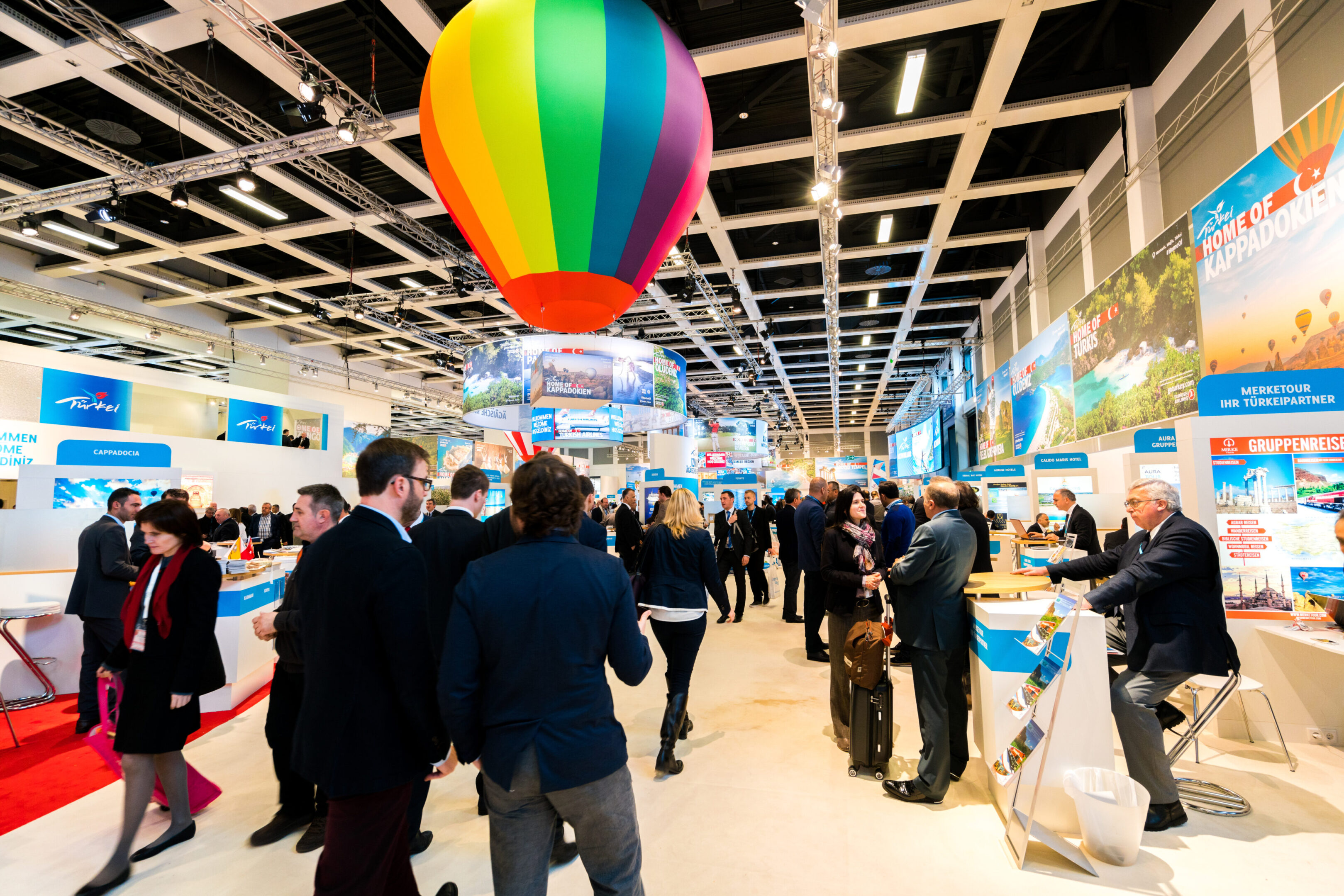 A crowd of people standing around in an indoor area.